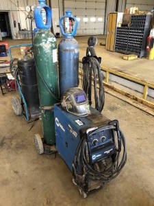 Miller Millermatic 252 Welder w/ Cart, Hoses, Gun, etc. (Bottles Not Included) Located at 310-2nd Ave. Fox Creek, AB T0H 1P0