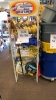 LOT OF ASSTD ITEMS: APPRX 120 PAIRS OF WORK GLOVES, EXTENSION CORDS, WATER HOSE, TRASH CANS, WATER JUGS, HEAVY DUTY C - CLAMPS, BRAKE FLUID, BOOSTER CABLES, HOOK SETS, AND HANGING BRACKETS WITH SHELVING AND RACK - 4