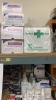 LOT OF ASSTD MEDICAL SUPPLIES: BAND AIDS, STING RELIEF PADS, SPORT TAPE, COHESIVE BANDAGES, BZK TOWELETTE, TONGUE DEPRESSORS, GAUZE PADS WITH 2 RACKS - 4